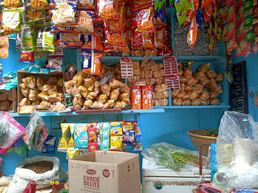Aisle view showing grocery shelves and everyday essentials in a village kirana and general store